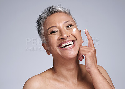 Buy stock photo Skincare, cream or happy senior woman, healthy skin or smile for beauty product on face against grey studio background. Elderly latino model happiness, cosmetic wellness and sunscreen for body health