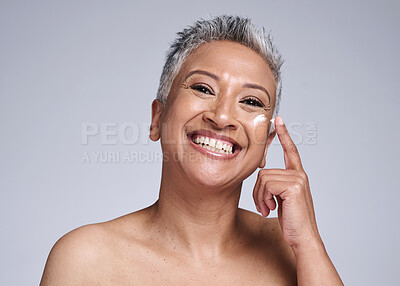 Buy stock photo Skincare, facial cream and senior black woman isolated on gray background in studio for spa. Beauty, wellness and portrait of old woman apply lotion, sunscreen or anti aging beauty products to face 