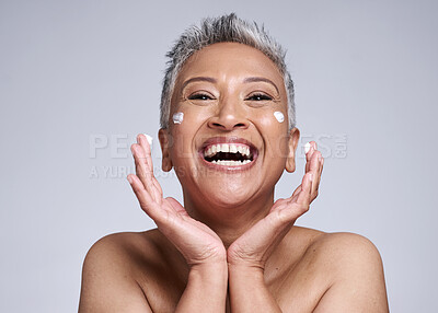 Buy stock photo Face, cream and happy senior portrait of woman with luxury dermatology product dots and playful smile. Anti aging, care and cosmetic lifestyle model with skincare beauty on gray studio mockup.

