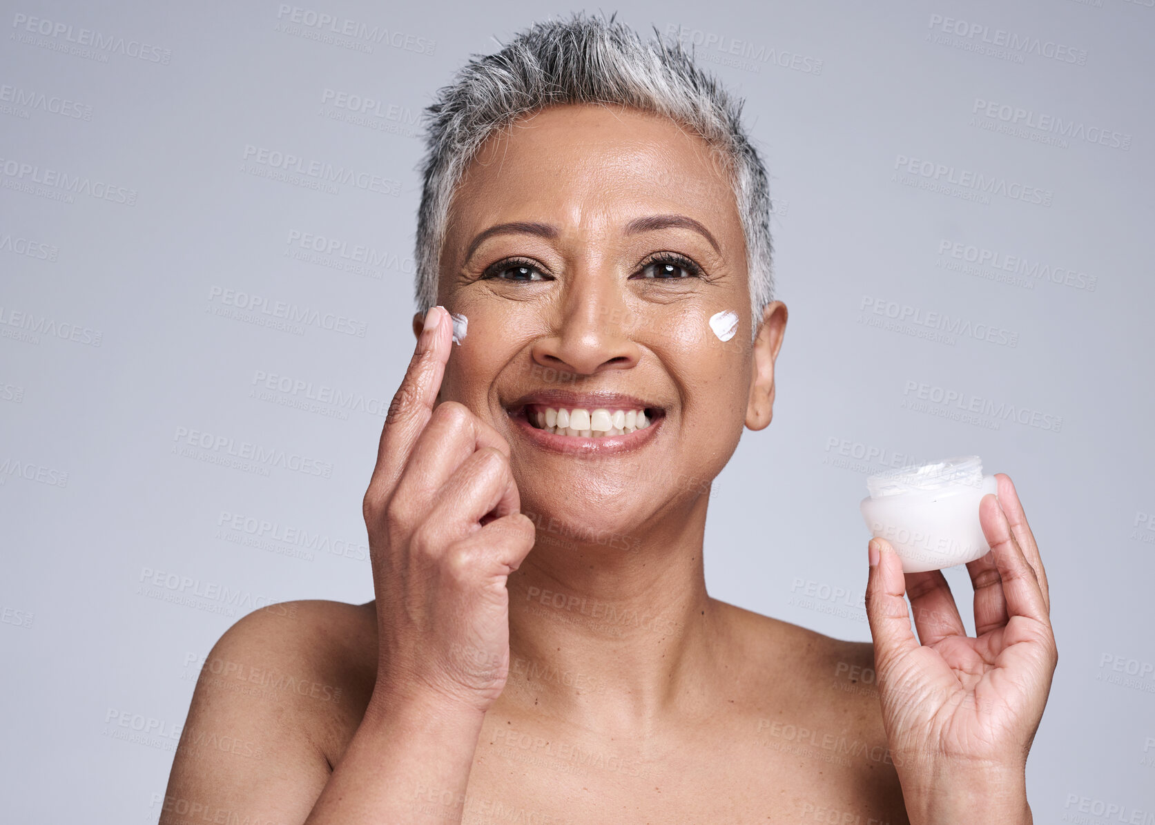 Buy stock photo Cream, face and skincare senior woman in studio portrait for healthy glow, wellness and cosmetics promotion, advertising or marketing. Happy anti aging elderly model with skin care dermatology facial