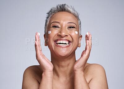 Buy stock photo Happy senior woman with skincare, beauty and healthy cosmetic skin with anti aging facial moisturizer cream. Portrait of health self care, lotion on face and smile in grey mockup studio background
