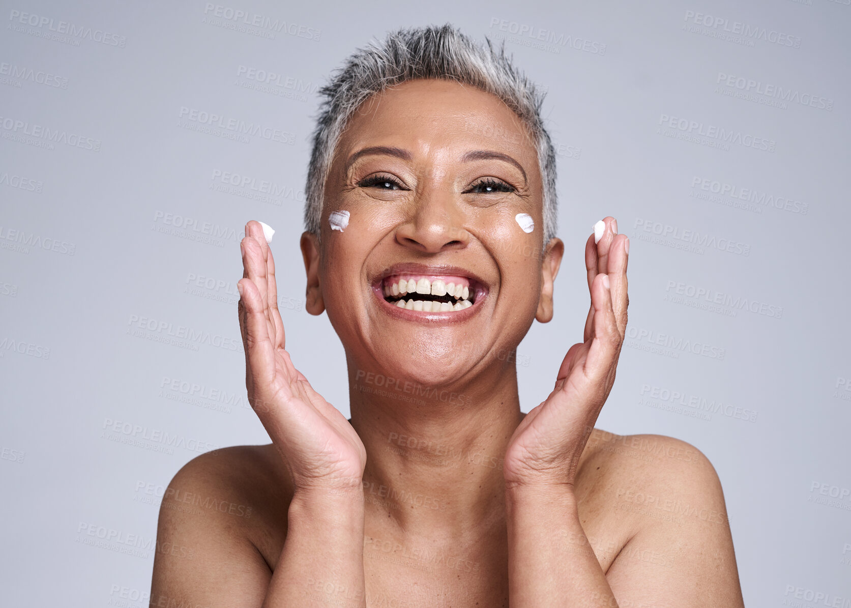 Buy stock photo Happy senior woman with skincare, beauty and healthy cosmetic skin with anti aging facial moisturizer cream. Portrait of health self care, lotion on face and smile in grey mockup studio background
