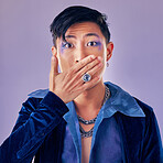 Surprised, shocked and gay man with makeup in a studio for pride, beauty and gender fluid cosmetics. Lgbtq, queer and homosexual guy with wow, surprise or omg expression isolated by purple background