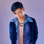 Asian man, fashion and cyberpunk makeup aesthetic for futuristic beauty or vintage clothes. Retro, creative pop art gen z model and funky rock style with metal chain in purple background studio 