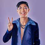 Fashion, peace sign and smile of punk man in studio with smile and vintage, retro or pop art clothes on color background for motivation. Gen z asian aesthetic lgbt or gay model with pride on purple