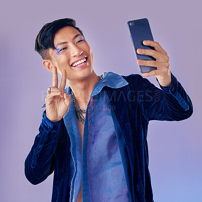 Buy stock photo Man, makeup art and selfie with phone for creative, skin or beauty with happiness against purple backdrop. Happy, model and photo with smartphone with face, cosmetic or fashion by lavender background