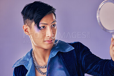 Buy stock photo Asian man with glitter makeup, mirror for creative beauty and lgbt gender performance in fantasy art. Purple background in studio, punk fashion jewellery in Seoul and proud of unique fluid identity