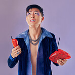Fashion, telephone and confused man in studio isolated on a purple background. Punk, phone call decline and gay model from Japan in makeup with retro or vintage phone, designer jacket and jewelry.
