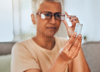 Buy stock photo Glasses, medicine and pills senior woman reading information for healthcare, insurance and wellness at home. Elderly or old woman check label bottle or container for medical pharmaceutical medication