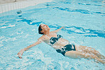 Relax, wellness and woman swimming in water at retirement home calm, peaceful and floating. Health, fitness and peace of senior swimmer in pool with happy smile excited for exercise break.