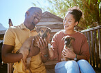 Dog, animal shelter and rescue with a black couple holding a puppy for adoption at a welfare kennel. Help, canine and volunteer with a man and woman adopting dogs from a charity organization