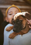 Dog, playing and child at a shelter for adoption, love and care with a pet in nature. German shepherd, happy and girl holding a young puppy at a park to play, fun and relax with bokeh background