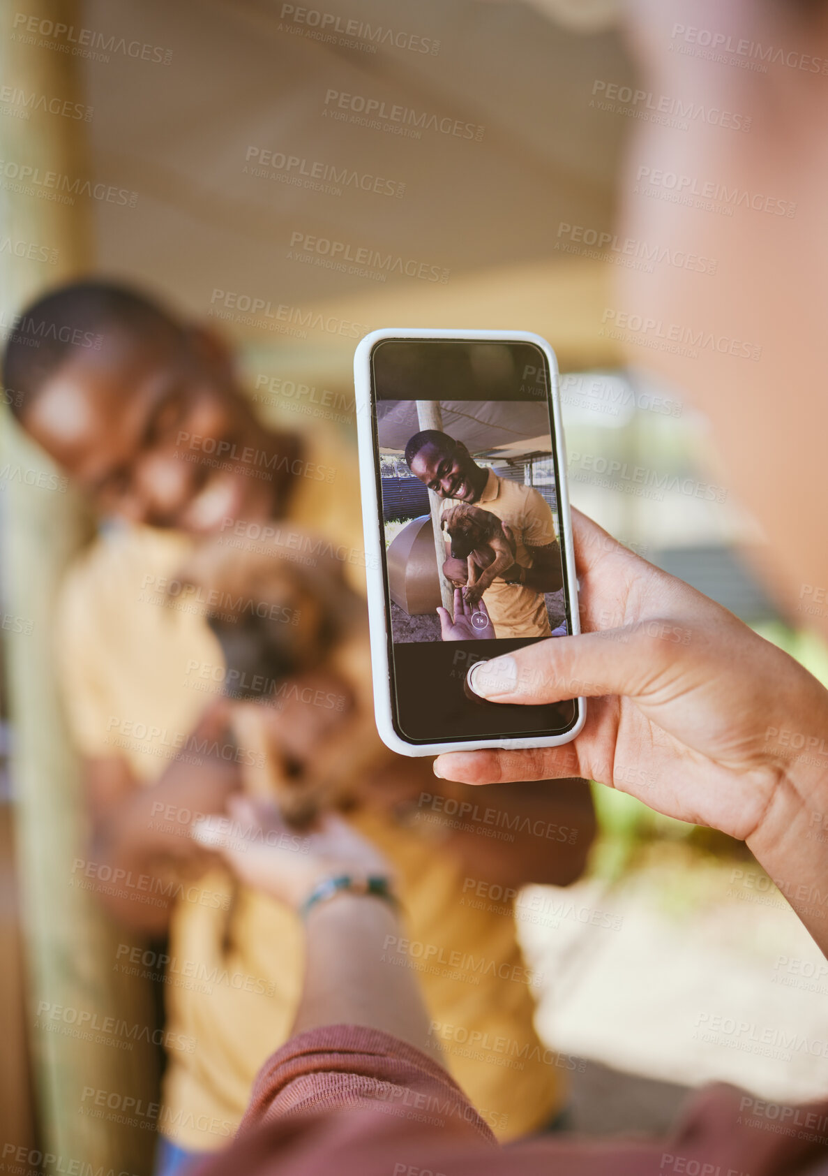 Buy stock photo Phone picture, dog and woman hand showing man and new pet outdoor with happiness. Black man, puppy and black woman together with couple bonding hug using mobile technology and camera with a smile