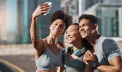 Buy stock photo Phone, selfie and fitness with a man and woman sports group taking a photograph together in the city. Health, teamwork and mobile with an athlete group posing for a picture in an urban town 