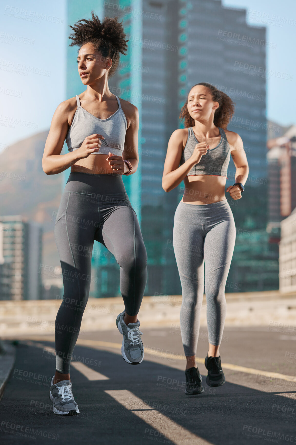 Buy stock photo Women, fitness and running on city street or road in workout, training or exercise for cardio health, marathon or wellness. People, friends and runner athletes in sports warmup with motivation goals