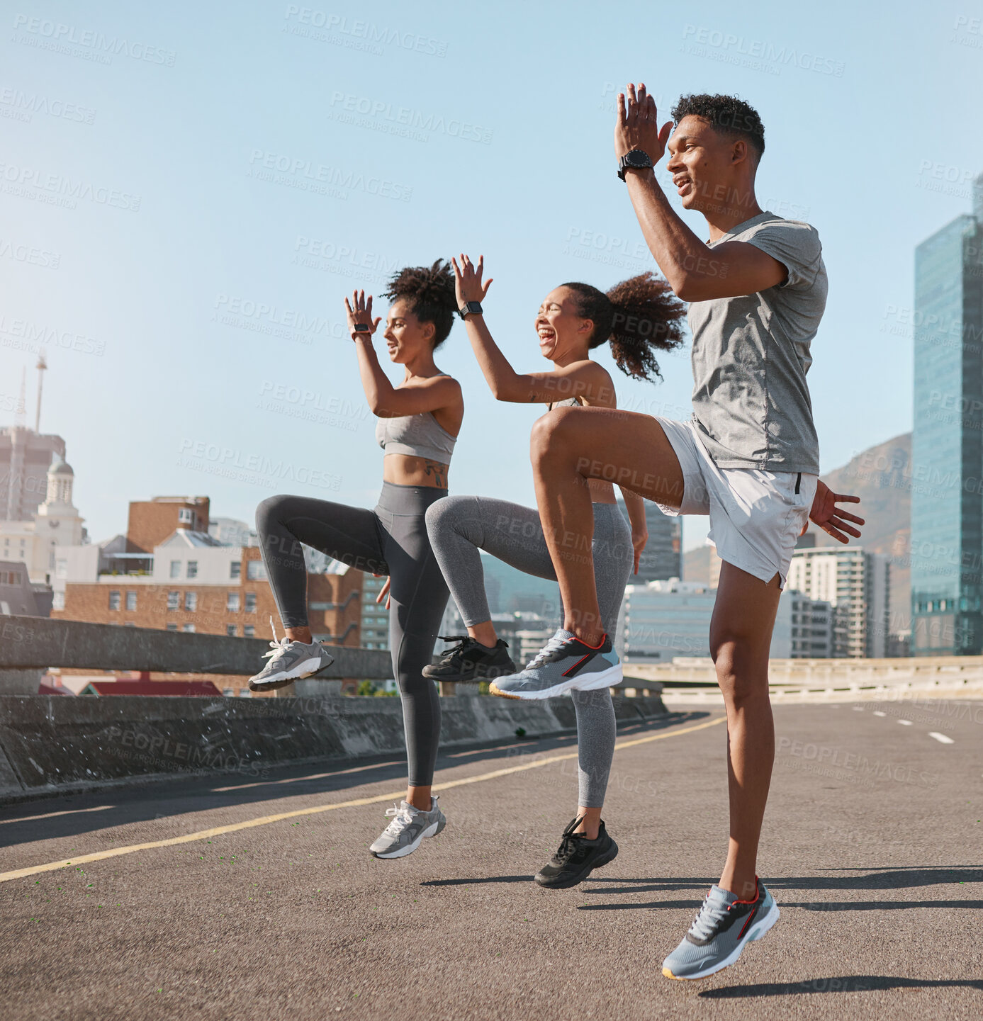 Buy stock photo Exercise, friends and jump training in city for health, wellness and fitness. Sports, people and teamwork of runner group in street exercising, workout and jumping practice outdoors on urban road.
