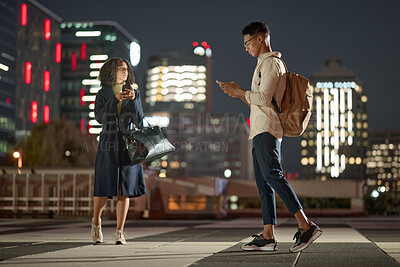 Buy stock photo Business people, phone and city at night, social media and order transport with online app in New york. Man and woman workers leaving urban town late after work day with 5g mobile smartphone on web