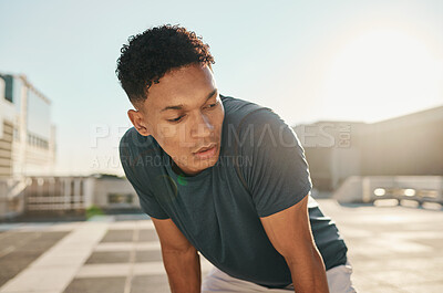 Buy stock photo Runner, fitness and tired man in a city fatigue from running exercise, cardio workout or training. Breathing, fatigue and healthy sports athlete relaxing or resting on a break from marathon training
