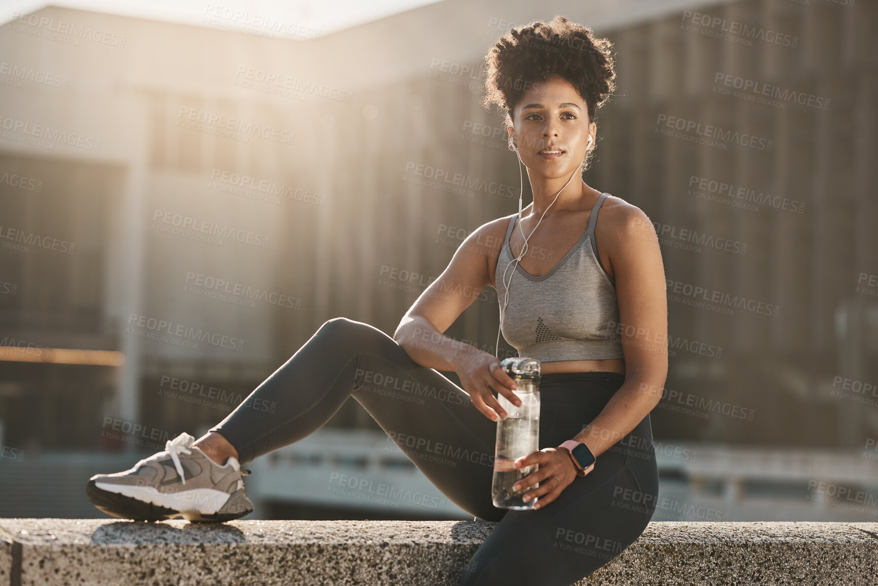 Buy stock photo Fitness, earphones and black woman, water bottle break and training workout, exercise and motivation in urban city. Thinking young athlete, sports hydration and nutrition for body, wellness and goals