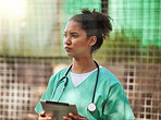 Veterinary, nurse of healthcare woman outdoor with tablet and stethoscope for inspection or to check medical records. Vet, veterinarian or doctor in uniform using technology for research or schedule