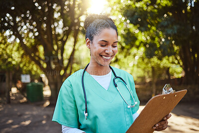 Buy stock photo Woman, nurse and smile looking at clipboard in healthcare, medical or prescription in outdoor park. Happy female doctor or veterinary in nursing examination report, check or inspection for diagnosis
