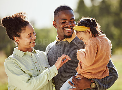 Buy stock photo Love, family and happy girl with parents in a park, laughing and playing while bonding in nature. Love, happy family and child relax, play and enjoy quality time with mother and father in a forest