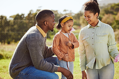 Buy stock photo Happy family, nature and child smell flowers while relax in countryside Spring field with mother, father or parents. Love, freedom peace or harmony for black man, woman and kid girl with floral plant