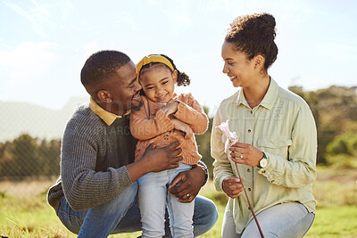 Buy stock photo Happy family, hug and nature with a mother, father and girl on an outdoor adventure in a green park. Black family, smile and travel of a mom, man and child bonding on a countryside field in spring