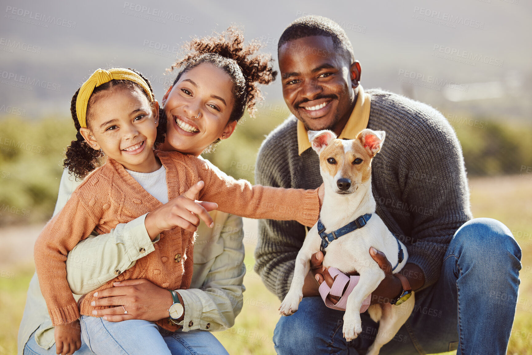 Buy stock photo Family, portrait and dog at park with girl and parents relax, bond and play, happy and smile in nature. Black family, pet and having fun on a field, embrace and enjoy quality time with jack russell