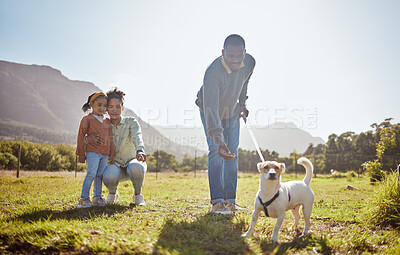 Buy stock photo Dog, walking and family relax together in nature park enviroment. Black family, pet and father walk puppy in garden with mother and child for freedom, happiness and animal care on countryside field