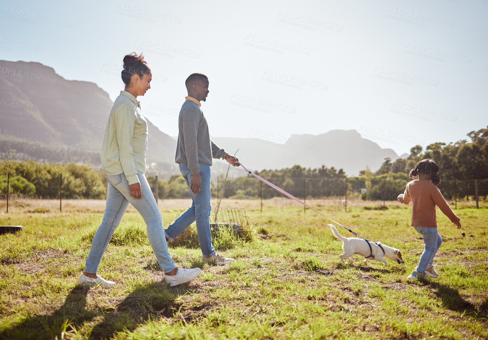 Buy stock photo Nature, pet and black family taking a walk with dog having fun, bonding and enjoying summer. Love, animals and mom and dad walking with young girl and puppy in park on weekend, holiday and vacation