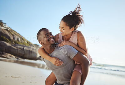 Buy stock photo Love, piggy back and black couple on beach walking, smile and happy together, for bonding and outdoor. Romantic, man carry woman or loving on seaside vacation, holiday and romance for relationship.