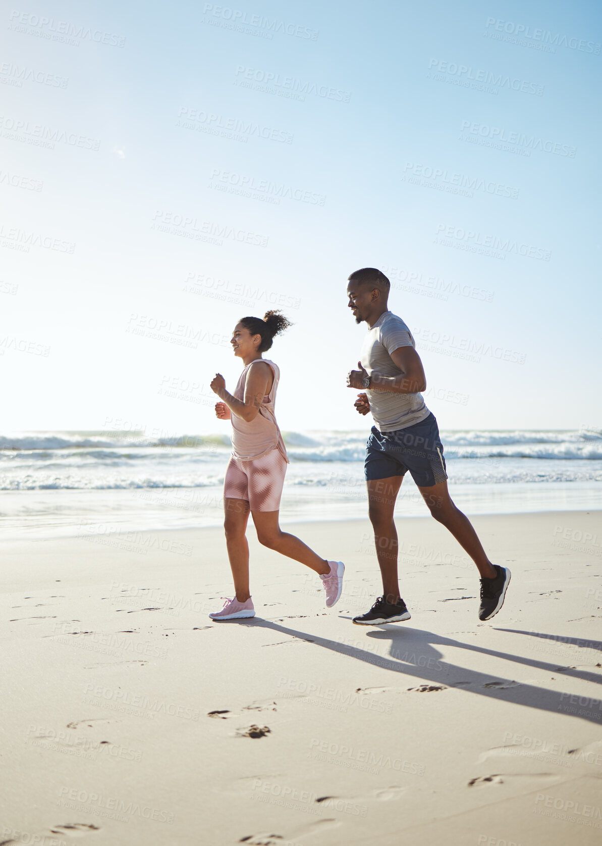 Buy stock photo Black couple, beach and running for fitness, exercise and cardio workout in sunshine, summer and sea sand. Young man, woman and runner partner on ocean with motivation for sports training in nature