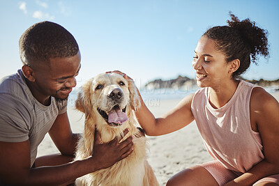 Buy stock photo Relax, couple and dog at a beach, happy and smile while bonding, sitting and touching their puppy against blue sky background. Love, black family and pet labrador enjoy a morning outing at the ocean