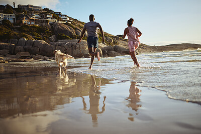 Buy stock photo Running, fitness and dog with couple at beach and training for health, workout and exercise together. Love, freedom and wellness with man and woman runner with pet by the ocean for sports and summer