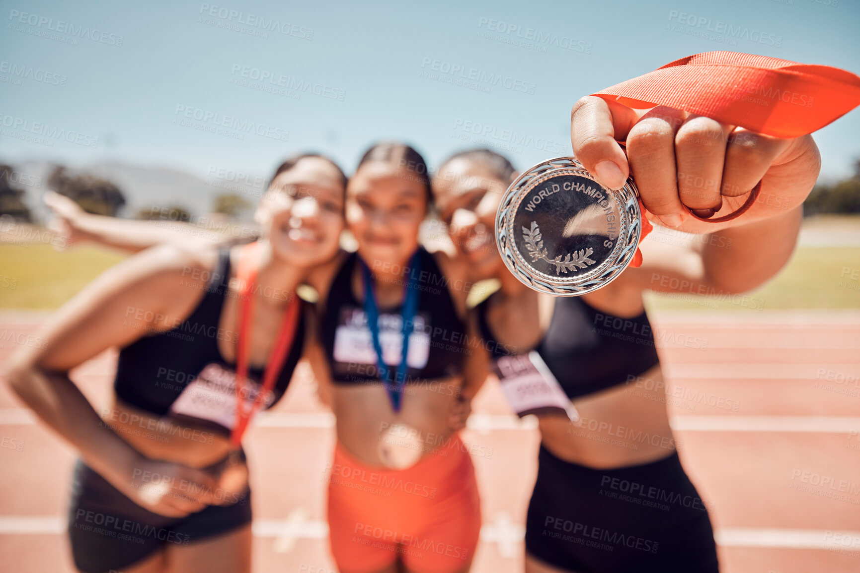 Buy stock photo Medal, winner team and athlete women, competition and success at sports stadium, arena and running track for race, olympics and world championship games. Excited runner group in pride for achievement