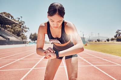 Buy stock photo Fitness, smartwatch or woman runner checking digital app for training, running marathon or workout in sports stadium track. Health or black woman with time monitor for wellness or marathon exercise