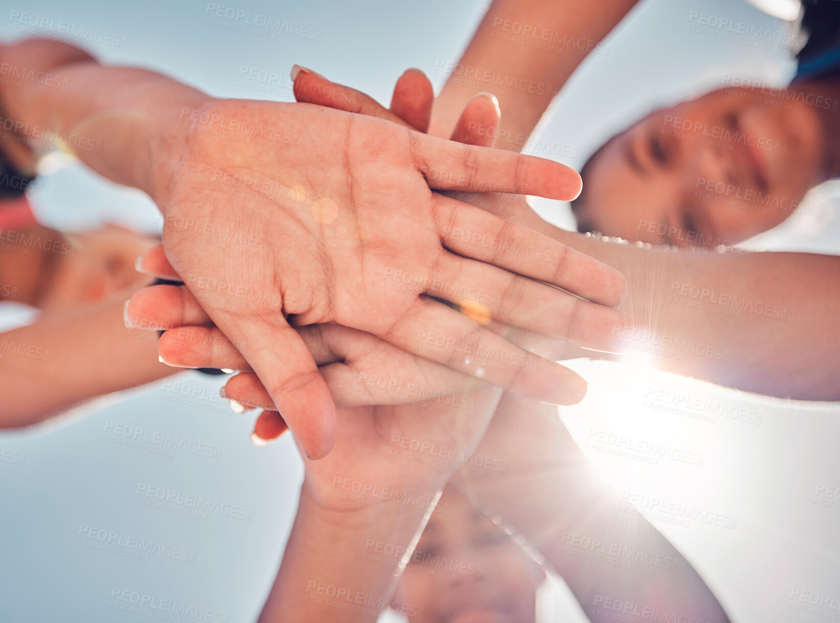 Buy stock photo Hands, teamwork and collaboration of friends, community or people together for charity, support and motivation outdoor with lens flare. Group together for trust, commitment and synergy from below