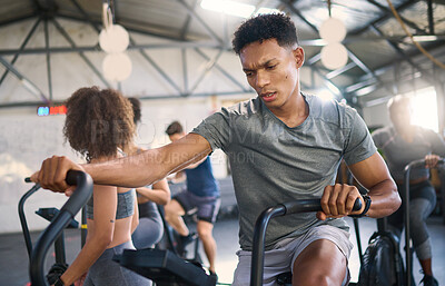Buy stock photo Gym, fitness and man on a spinning bike for exercise, health and cross training, power and motivation. energy, spinning bike and black man on air bike and sports center for wellness, workout and fit
