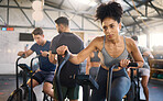 Fitness, class and bike workout of a black woman in a cycling, training and exercise studio. Bicycle sport, gym wellness and sports health club with a person on a machine with athlete motivation 