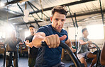 Bike, class and exercise man portrait with cycling training, wellness and fitness gym group. Athlete with motivation doing a bicycle, sports and spinning workout at a health cub or studio with people