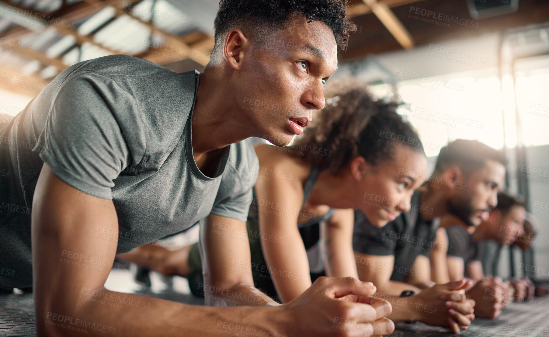 Buy stock photo Gym, fitness and plank floor workout, challenge and power exercise by young people, focus and mindset. Training, planking and group on the ground for wellness, health and muscle, energy and strength