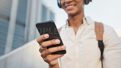 Buy stock photo Hand, phone and social media with a business black man typing a text message during a commute. City, mobile and contact with a male employee using a smartphone for communication, networking or music