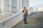Music, stairs and city with a business black woman walking outdoor while using headphones for streaming audio. Steps, commute and listening with a female employee streaming audio in an urban town