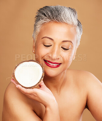 Buy stock photo Beauty, coconut and skincare with woman in natural cosmetic product advertising against studio background. Healthy skin, fresh and clean with organic cosmetics, face and body care for antiaging.