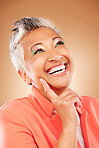 Thinking, happy and senior woman with fashion, vision for makeup and designer clothes against a brown studio background. Motivation, creative and elderly person with an idea for cosmetics and style