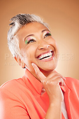 Buy stock photo Thinking, happy and senior woman with fashion, vision for makeup and designer clothes against a brown studio background. Motivation, creative and elderly person with an idea for cosmetics and style