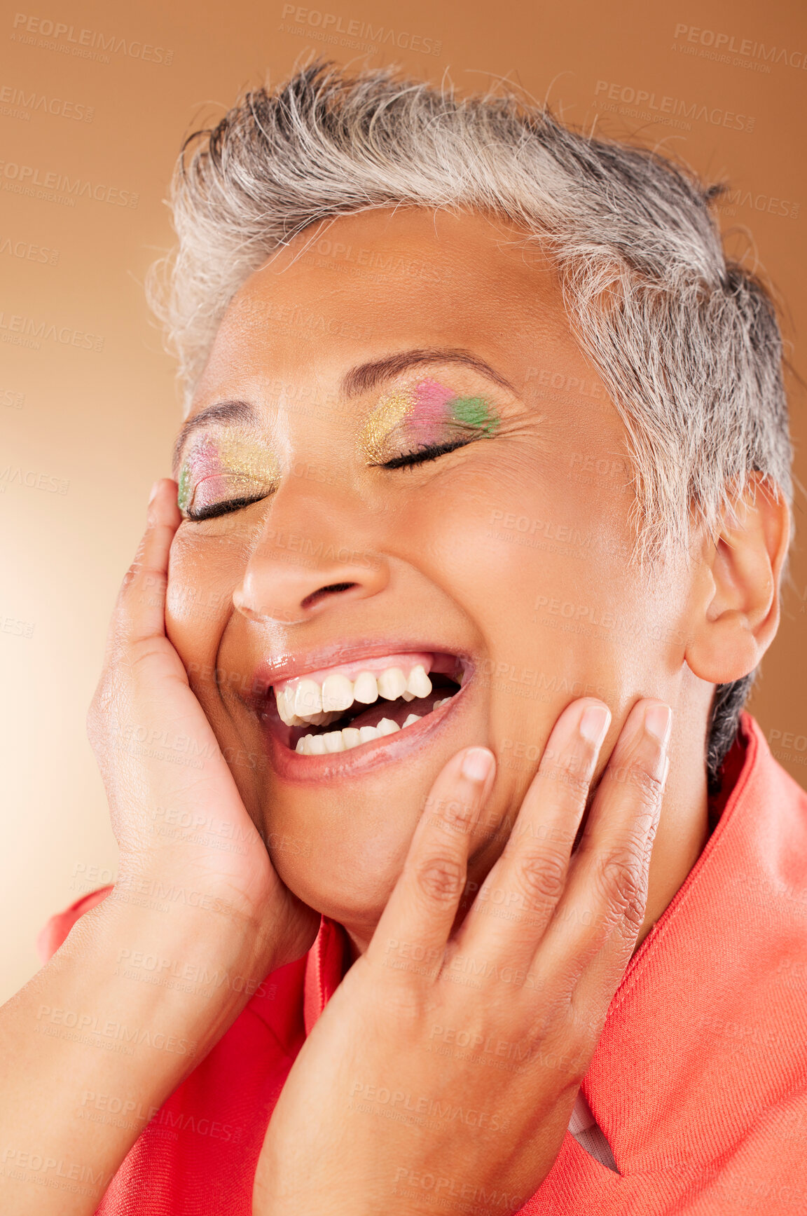 Buy stock photo Happy, color and senior woman with makeup standing in a studio with colorful, trendy and edgy cosmetics. Happiness, smile and elderly lady with a beauty routine isolated by gradient brown background.