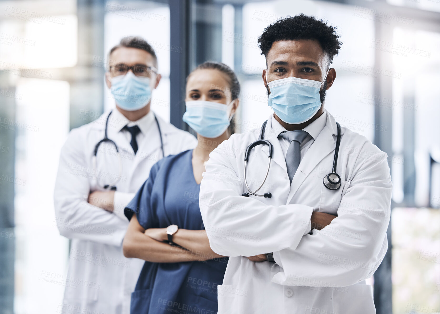 Buy stock photo Face mask, team and portrait of medical doctors standing in the hallway or corridor of a hospital. Teamwork, collaboration and group of healthcare employees ready for a covid consultation in a clinic
