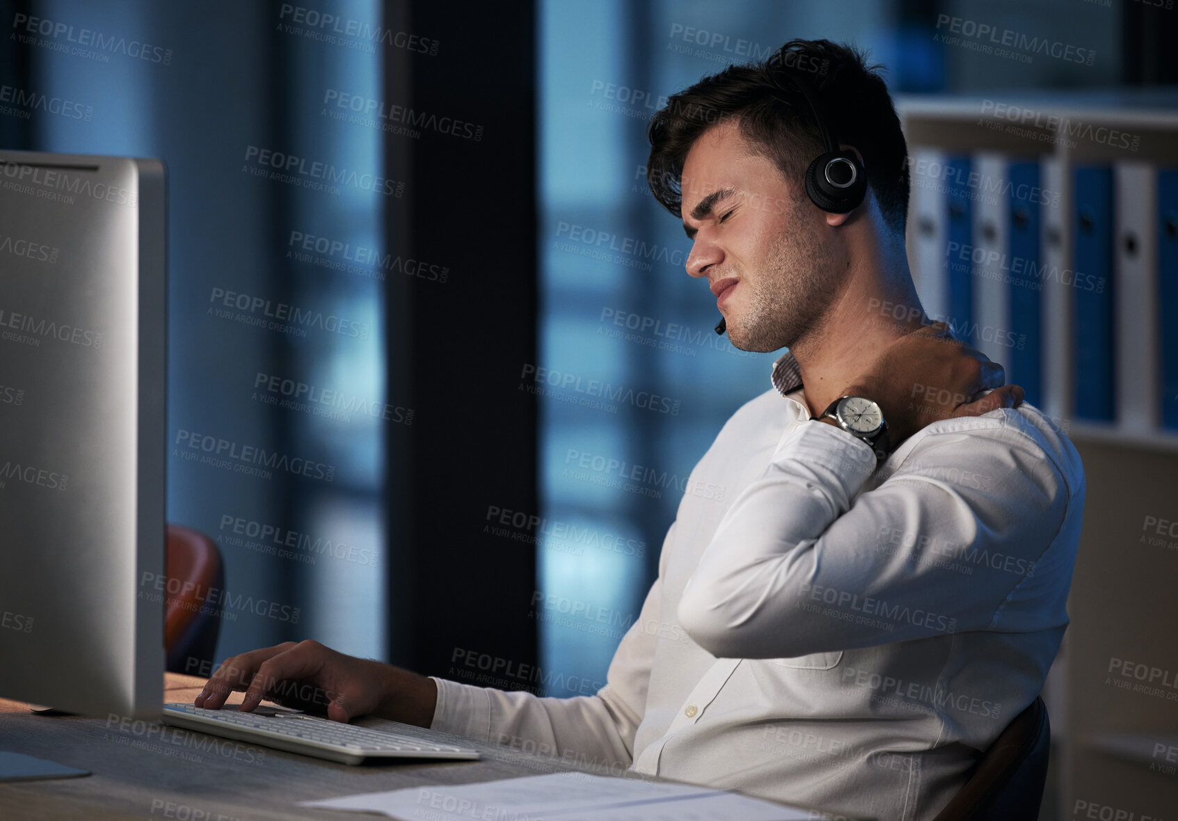 Buy stock photo Call center, neck pain and business man at night with burnout, stress and fatigue at office desktop computer consulting. Telemarketing or salesman consultant with shoulder pain or health risk problem